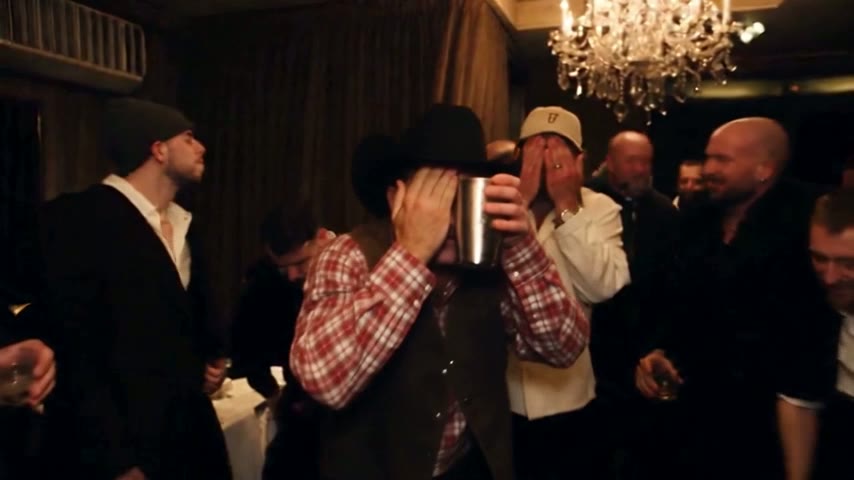 Cowboy in a black hat and suede vest, hand over his eyes