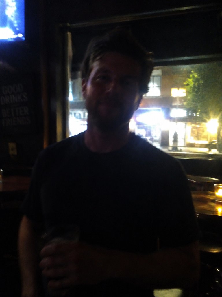 Dim, backlit, blurry snapshot of a person